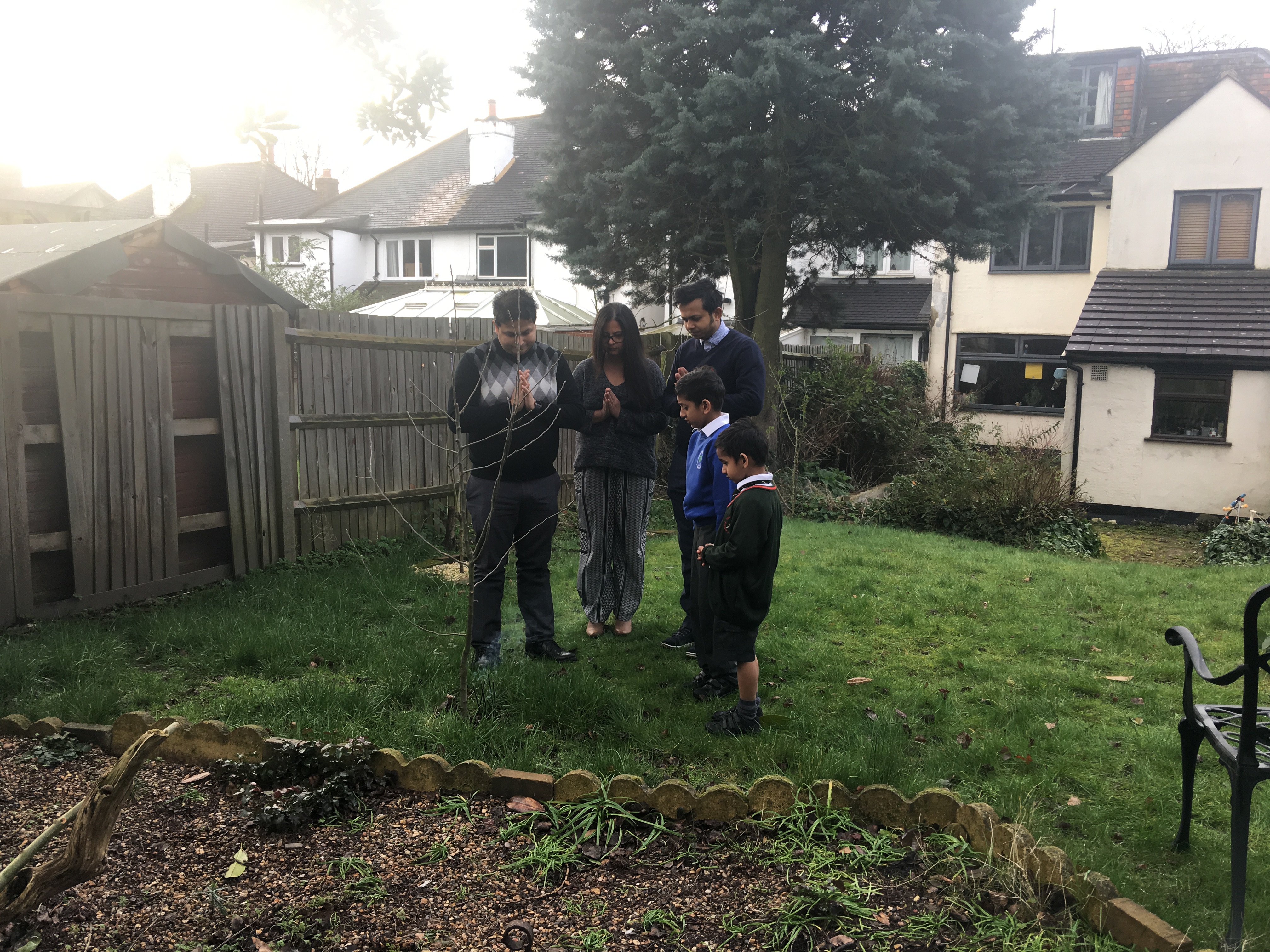 Gathering around his apple tree to offer respects