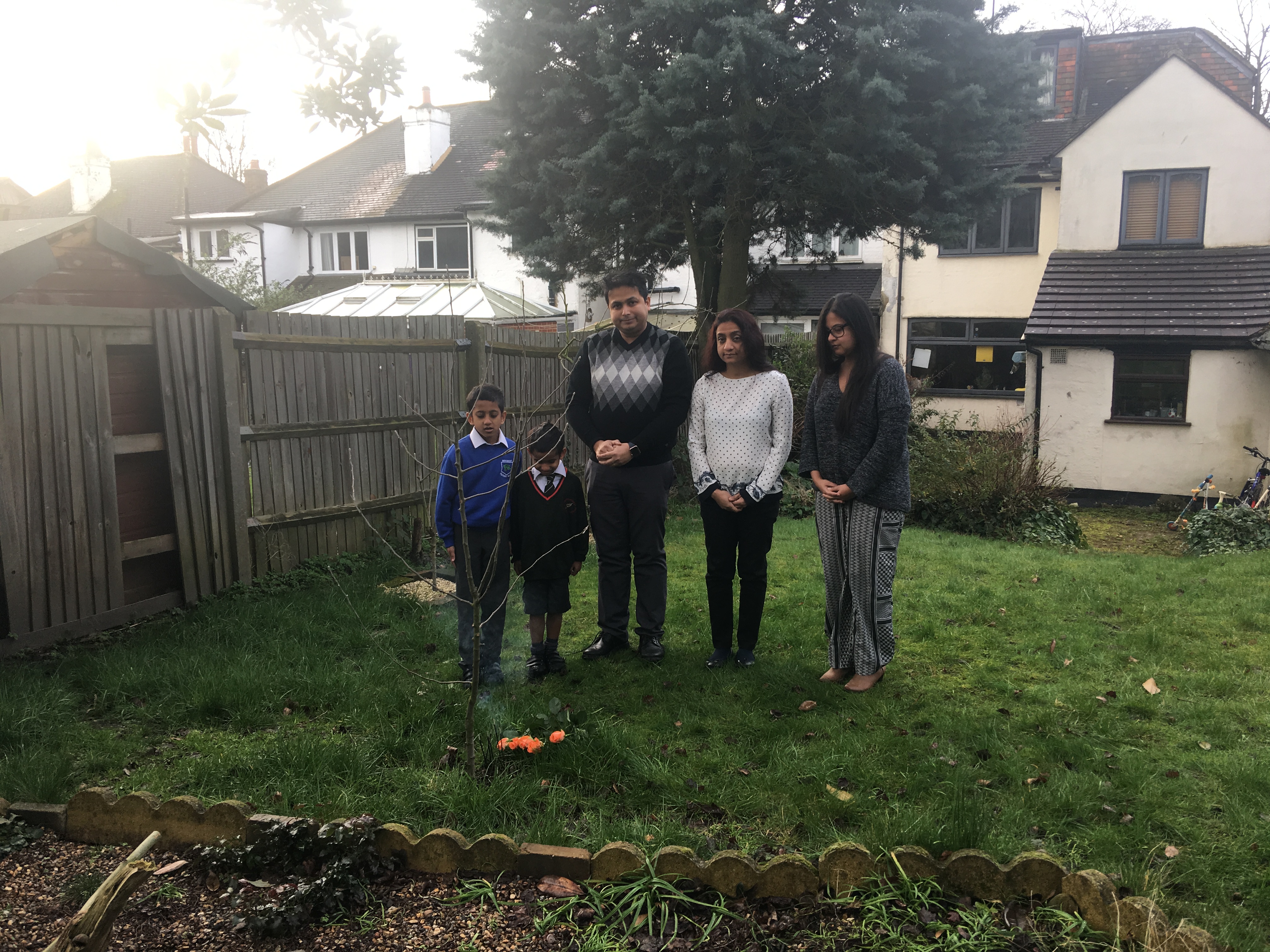 Gathering around his apple tree to offer respects